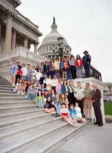 Congressman John W. Olver with group of visitors, posed on the steps of the United States Capitol building