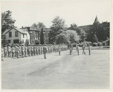 Army Air Corps in formation in parking lot by Marsh Memorial Building (May 1943)