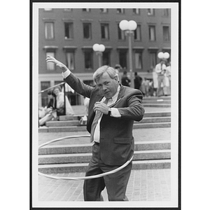 Man in suit using hula hoop for Participation Challenge event