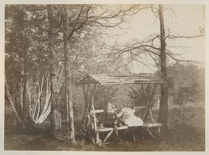 Boy and Girl Sitting on Wooden-covered Bench: Melrose, Mass.