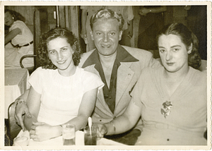 Manny Dias posing with two women