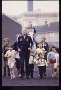 Gusty Spence jogging with children past Crumlin Road Jail