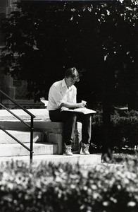 Student reading on the steps of Bapst Library at Boston College