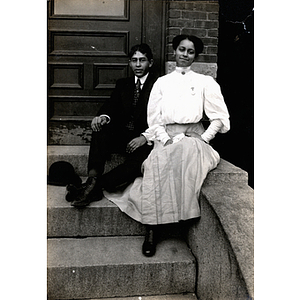 Couples photograph, man and woman sitting on stoop