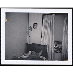 A teenage boy from the Charlestown Boys' Club, asleep on bed