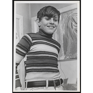 A smiling boy in an art class at the Boys' Clubs of Boston