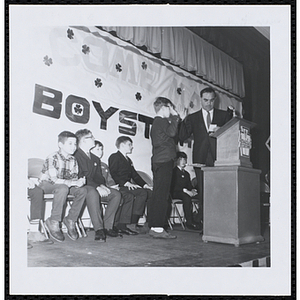 A boy takes an oath at a Boys' Club of Boston St. Patrick's Day inaugural ball and exercises event