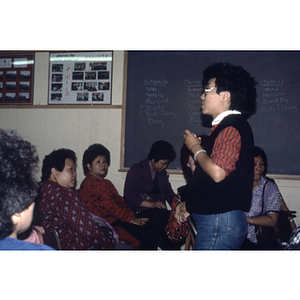 Woman speaking to garment workers