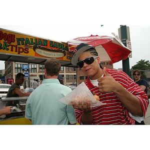 Danny Vazquez gives a thumbs-up while eating outside Fenway Park