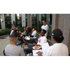 Students outdoors at the Torch Scholars Question and Answer Pizza Party