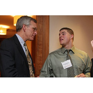 Joseph Bordieri stands with a man at a Torch Scholars event