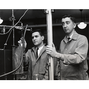 Two students conduct experiments in a chemical engineering laboratory