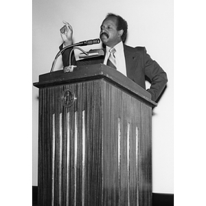 John D. O'Bryant speaking from behind a podium