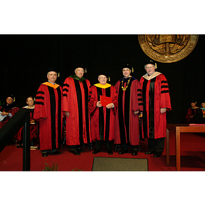 George Kostas on stage during commencement with his honorary degree