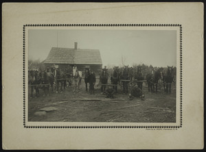 Men standing next to horses in front of a lumber mill, location unknown, undated