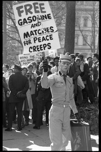 American Nazi Party counter-protesterm Douglas L. Niles, in uniform, carrying a sign reading 'Free gasoline and matches for peace creeps': Washington Vietnam March for Peace