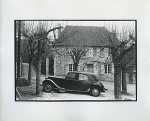 Car parked in front of stone house in France