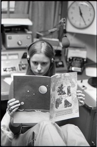 Unidentified woman reading Free Spirit Press magazine in radio broadcast studio