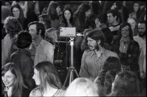 Wedding of Jim and Anne Baker: Bruce Geisler with video camera standing among wedding guests