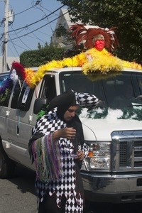 Parade marchers in particolored jester's outfit : Provincetown Carnival parade