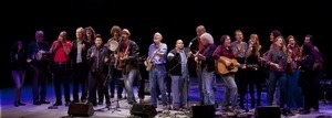 Pete Seeger (center on banjo) and other performers crowding the stage at Symphony Space, New York City, in a concert to pay tribute to George Wein