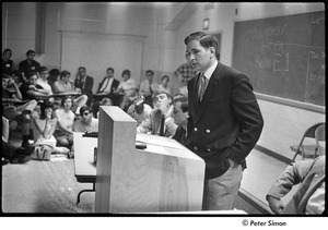 National Student Association Congress: man speaking at podium, Allard Lowenstein seated on right, just out of frame