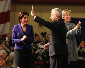 Hillary Clinton on stage with Rhode Island Sen. Jack Reed and Gov. Gina Raimondo