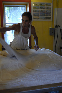 Hungry Ghost Bread: baker working dough for cinnamon rolls