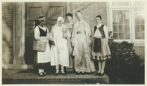 Women in costume on doorstep