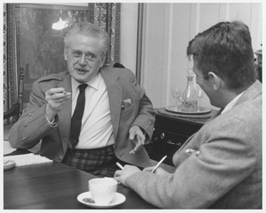 Hugh MacDiarmid, sitting at dining table with a gentleman, both men are smoking