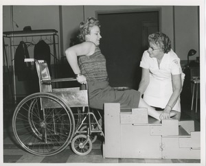 Physical therapist assisting Mrs. Frances Marsala in her exercises