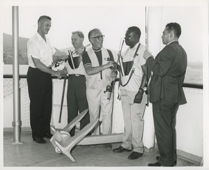 Men with fishing rods shake hands