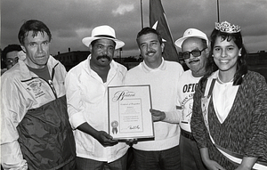 Police Commissioner Francis M. "Mickey: Roache with Jorge Rivera Ortiz and two unidentified men holding a certificate of recognition and the unidentified queen of the Puerto Rican Festival