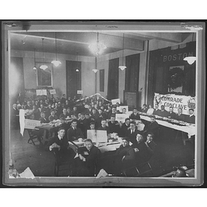 Boys seated at an event labeled "Comrade Conclave"