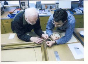 Examination of antique picture frame in conservation laboratory of the New Bedford Whaling Museum
