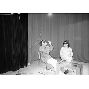 Two young women on the set of Villa Victoria's public access television station.