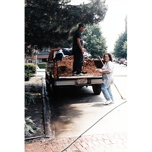 Man and woman with a pick-up truck full of mulch.