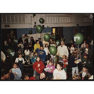 Children and adults gather in an auditorium with green "Charlestown Against Drugs CHAD" balloons during a Boys & Girls Club awards event