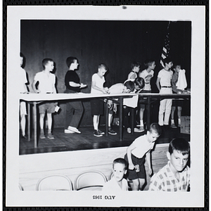 Boys participate in an eating contest at a carnival