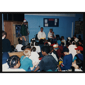 Children attend a gun awareness event with community activist and author Michael Patrick MacDonald (background, seated center)