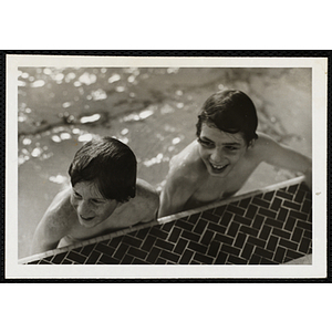 Two boys pose for a shot in a pool