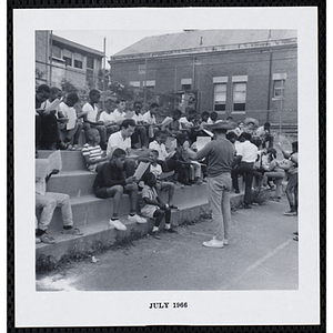 A man leads a group of boys in sing-along on Tom Sawyer Day