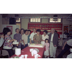 Henry Wong and guests cut a cake at a Chinese Progressive Association anniversary event