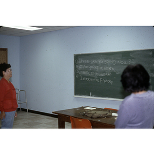 Two people with a chalkboard