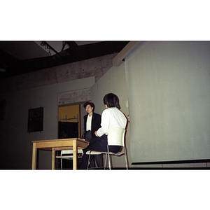 Two women talk at a voter registration event