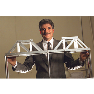 Mishac Yegian, a professor in the civil engineering department, standing behind a model