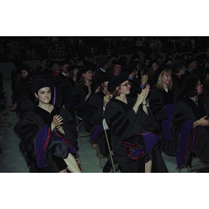 Graduates clapping at the School of Law commencement