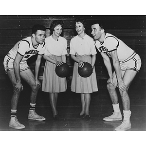 Twin female students hold basketballs and stand with twin male basketball players