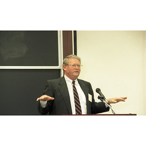 Neal Finnegan speaks at a podium at the College of Business Administration's 75th Anniversary Symposium