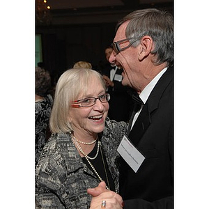 Martyn Culverhouse, right, dancing with a guest at a dinner honoring members of the Huntington Society